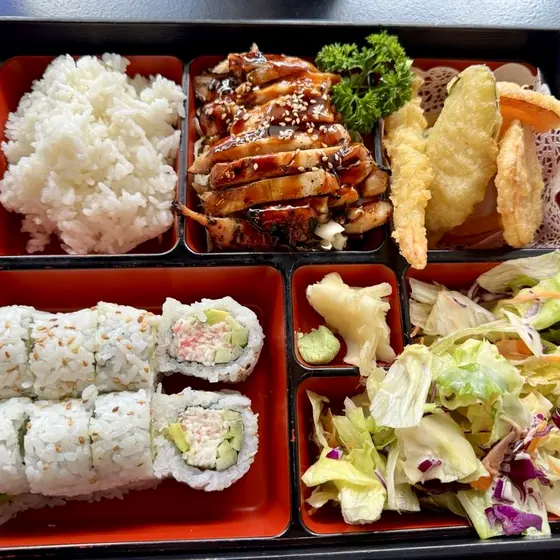 Bento box with rice, teriyaki, tempura and roll