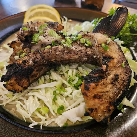 Grilled yellowtail collar on shredded cabbage