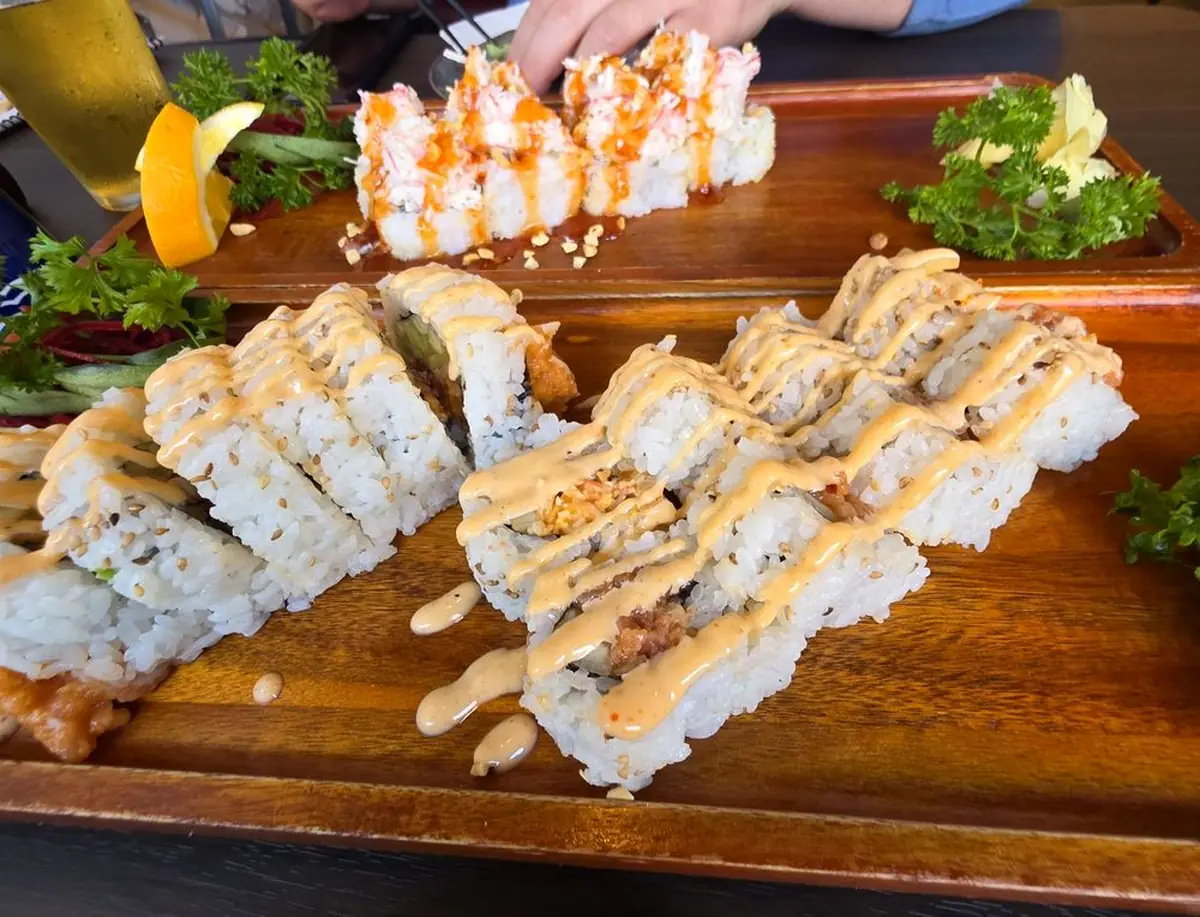 Rolls lined up on a wooden serving board